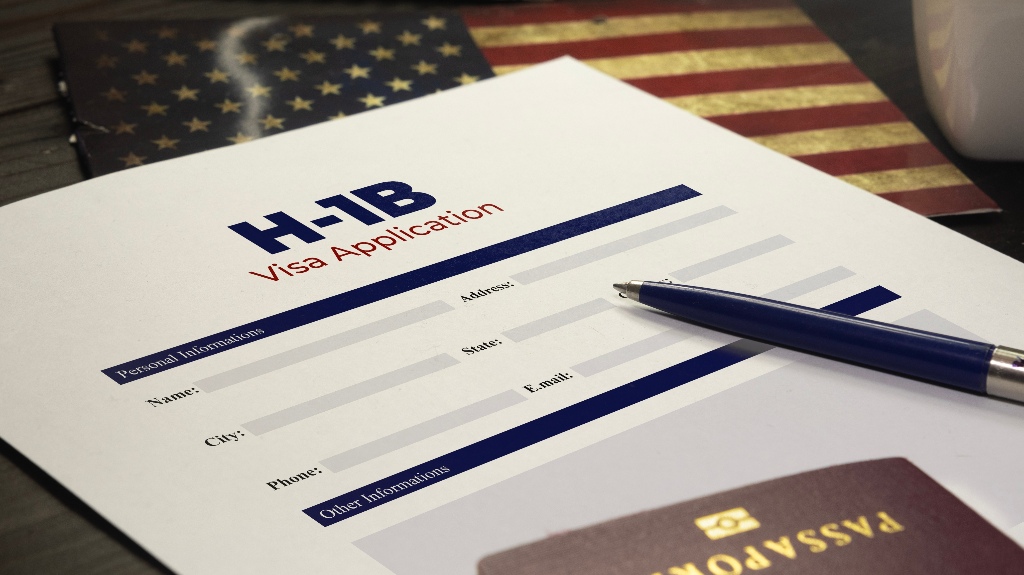 USA H-1B visa application on a table with a passport
