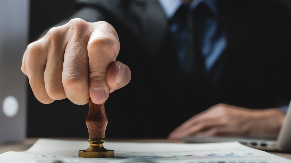 Man is putting stamp on the document