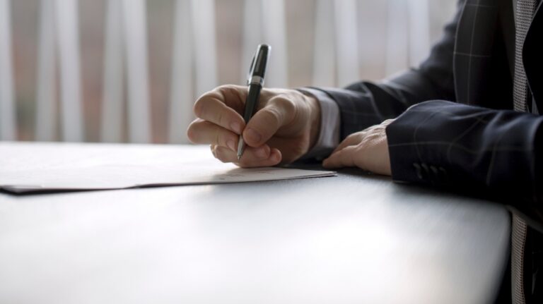Man is signing documents