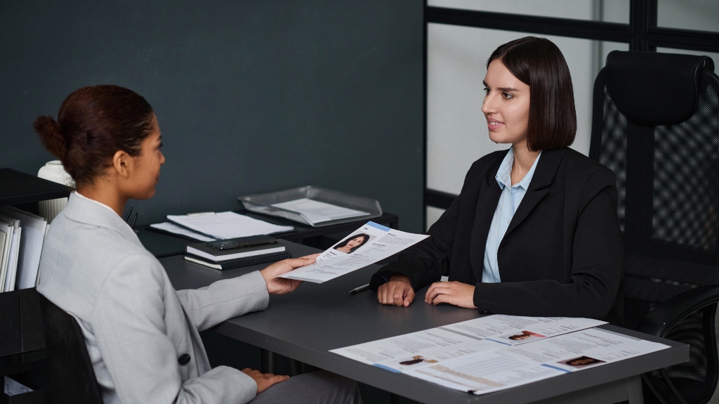 Woman giving her documents to apply visa