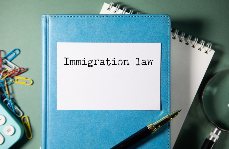 Word writing text immigration law on notepad